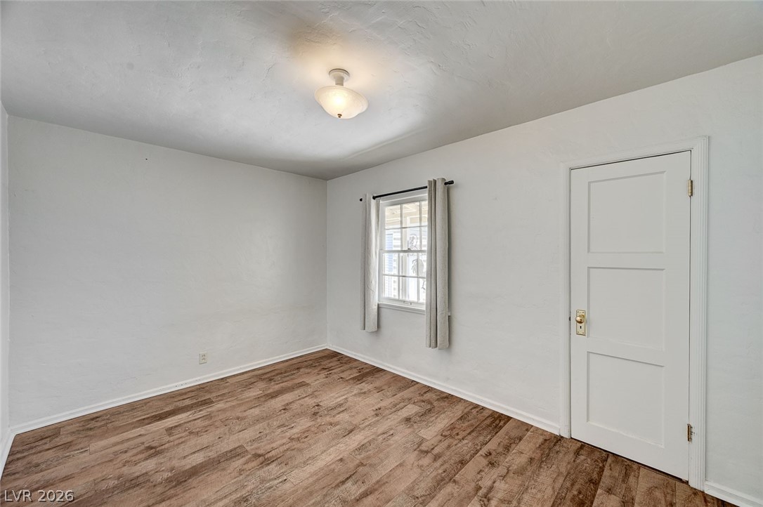 629 L Avenue Boulder City, NV 89005 - Photo 27 of 46 Spare room featuring wood finished floors and baseboards
