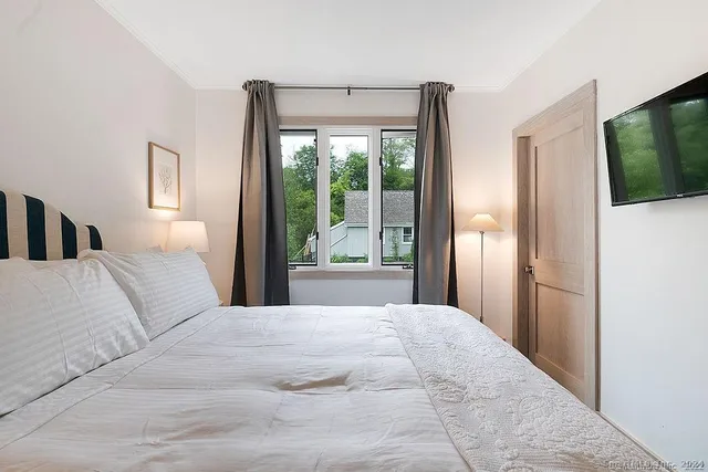 a bedroom with a bed and a couch