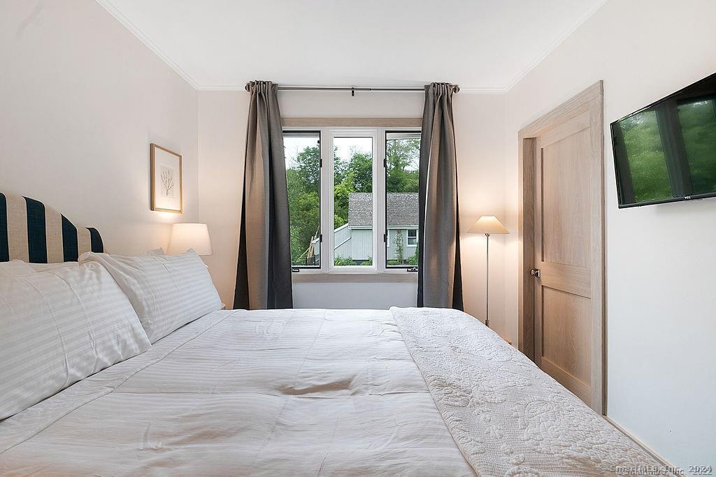 143 Melius Road Warren, CT 06754 - Photo 14 of 35 a bedroom with a large bed and a large window