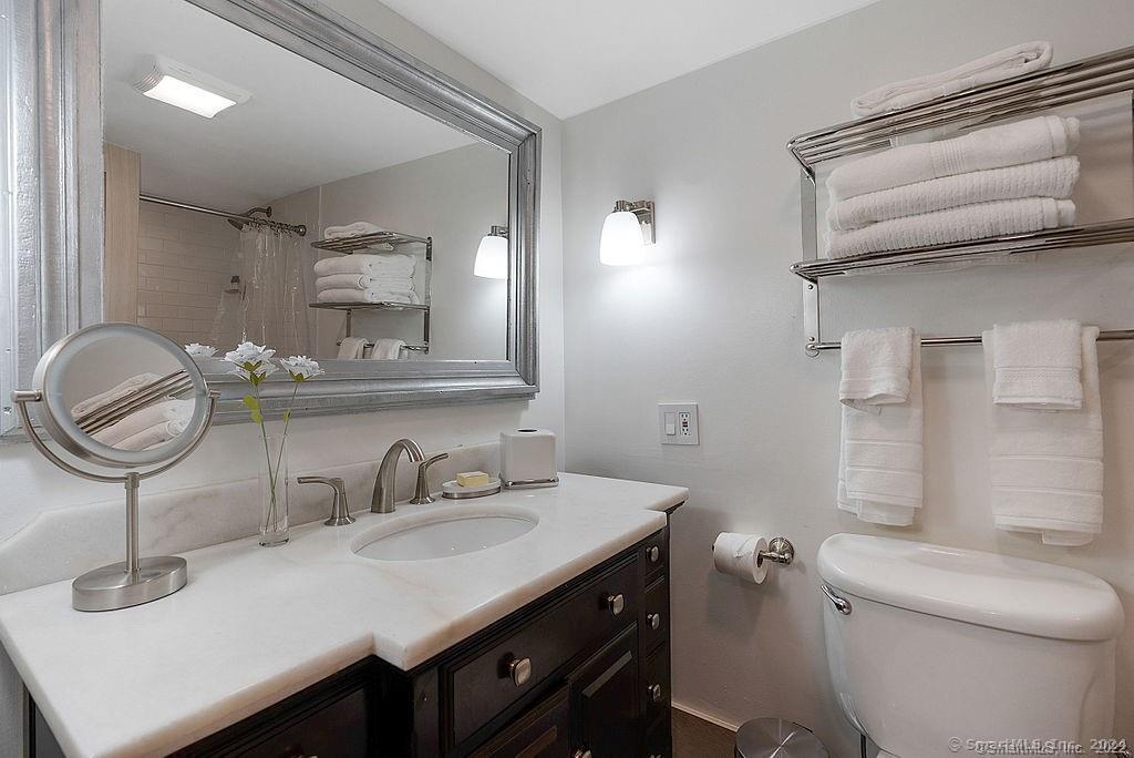 143 Melius Road Warren, CT 06754 - Photo 19 of 35 a bathroom with a sink a toilet and a mirror