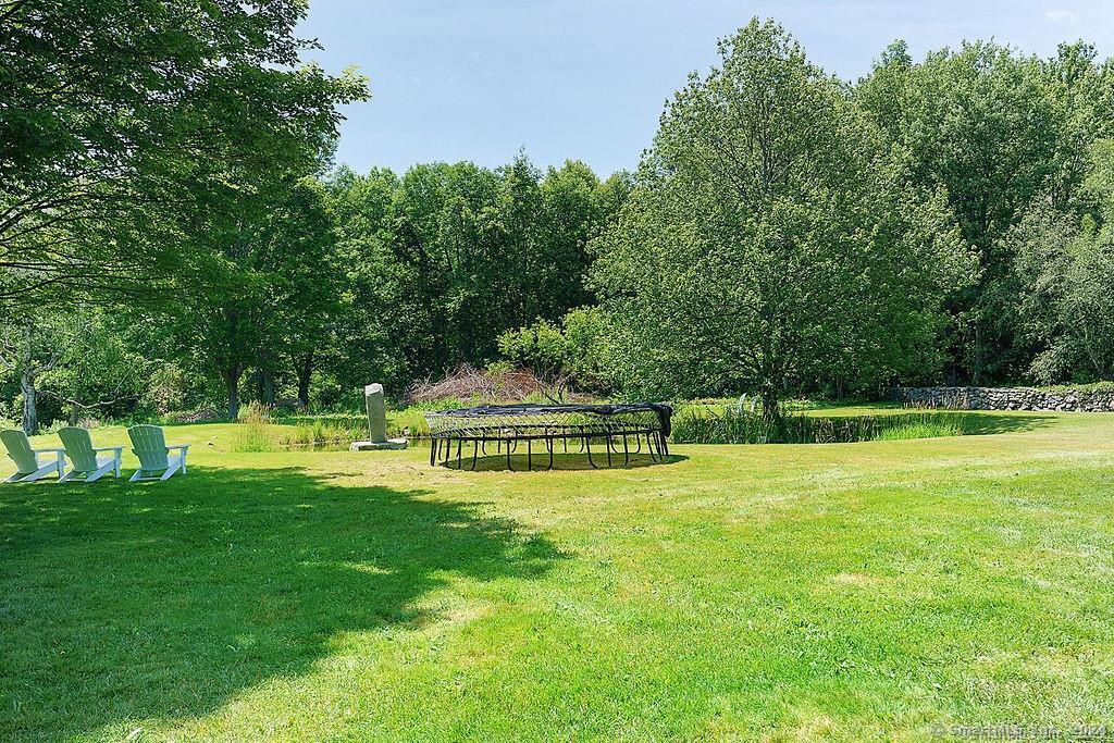 143 Melius Road Warren, CT 06754 - Photo 22 of 35 a view of a swimming pool with a yard