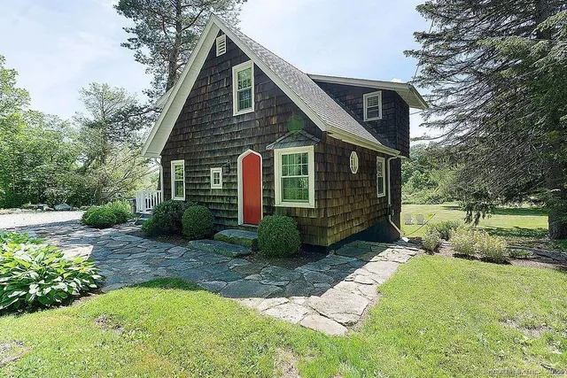 a view of a house with a yard and plants