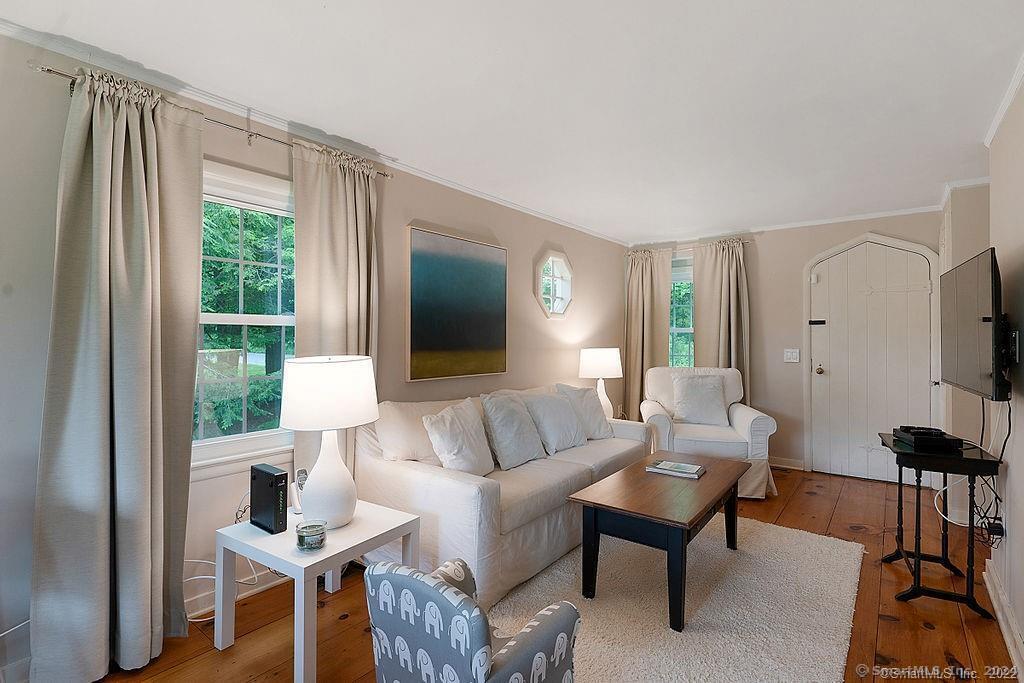 143 Melius Road Warren, CT 06754 - Photo 28 of 35 a living room with furniture a flat screen tv and a large window