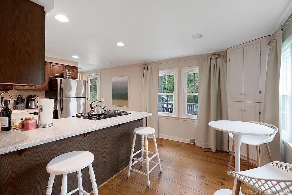 143 Melius Road Warren, CT 06754 - Photo 31 of 35 a kitchen with a table and chairs in it