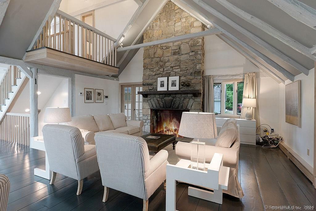 143 Melius Road Warren, CT 06754 - Photo 6 of 35 a living room with furniture a fireplace and a table