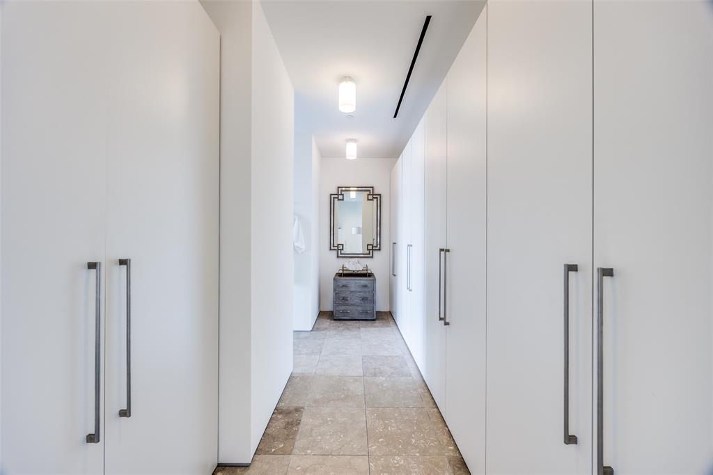 1717 Arts Plaza, Unit 1808 Dallas, TX 75201 - Photo 14 of 30 Hallway featuring baseboards and light stone finish flooring
