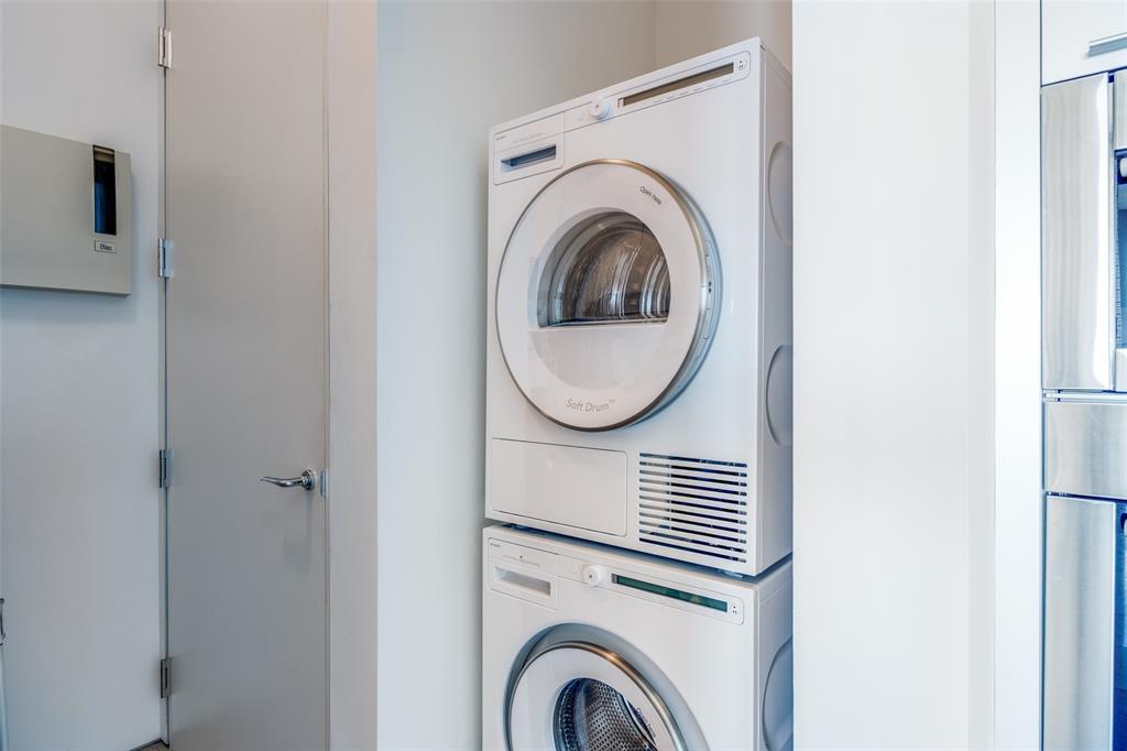 1717 Arts Plaza, Unit 1808 Dallas, TX 75201 - Photo 20 of 30 Laundry area featuring estacked washer and dryer