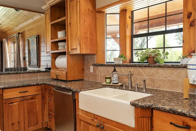 a kitchen with granite countertop a sink and a window