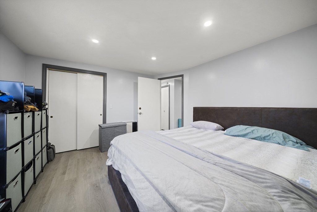 183-185 Middle Street Springfield, MA 01104 - Photo 12 of 27 a spacious bedroom with a bed and a wooden floor