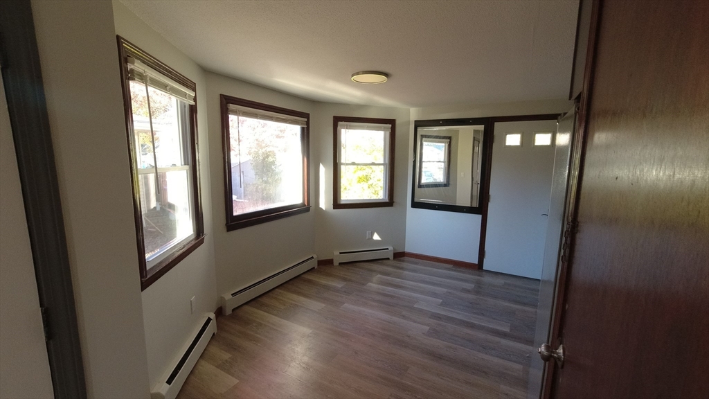 183-185 Middle Street Springfield, MA 01104 - Photo 20 of 27 an empty room with wooden floor and windows
