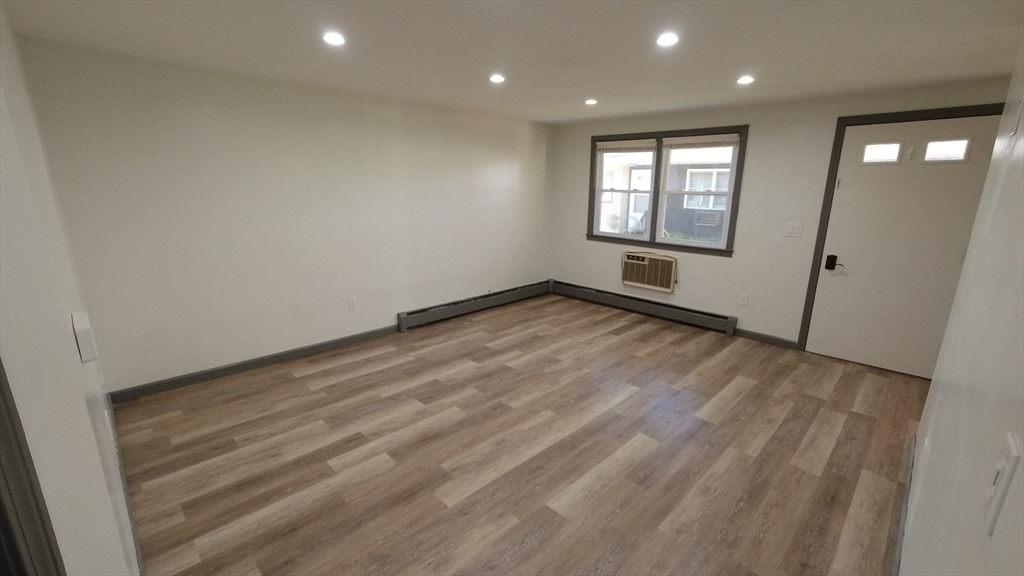183-185 Middle Street Springfield, MA 01104 - Photo 21 of 27 wooden floor in an empty room with a window