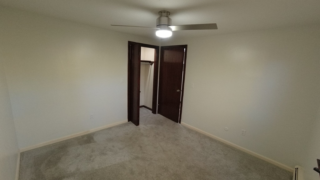 183-185 Middle Street Springfield, MA 01104 - Photo 24 of 27 an empty room with a ceiling fan and a window
