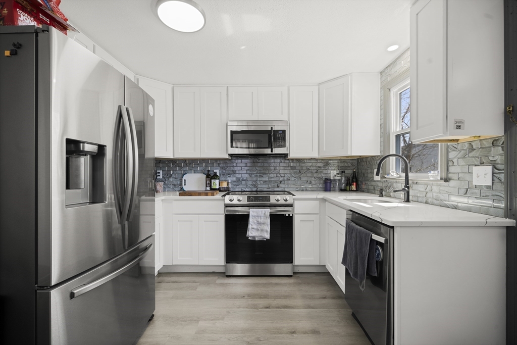 183-185 Middle Street Springfield, MA 01104 - Photo 6 of 27 a kitchen with stainless steel appliances granite countertop a sink stove and refrigerator