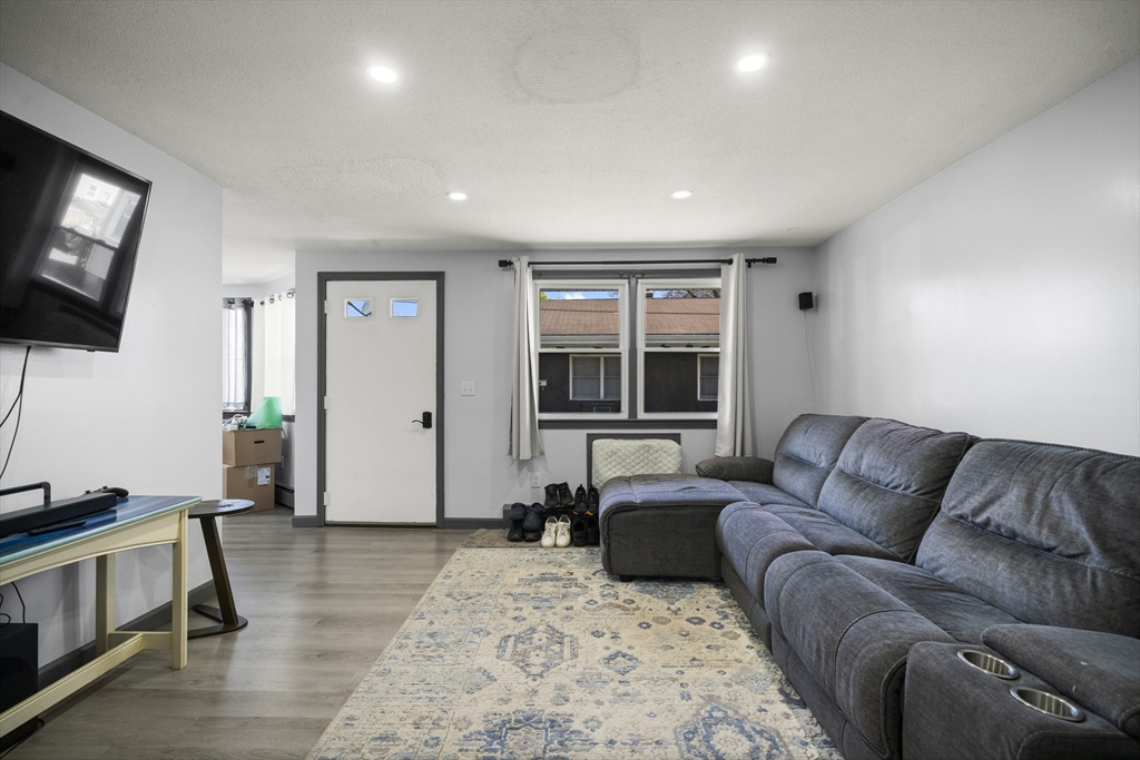 183-185 Middle Street Springfield, MA 01104 - Photo 7 of 27 a living room with furniture window and flat screen tv