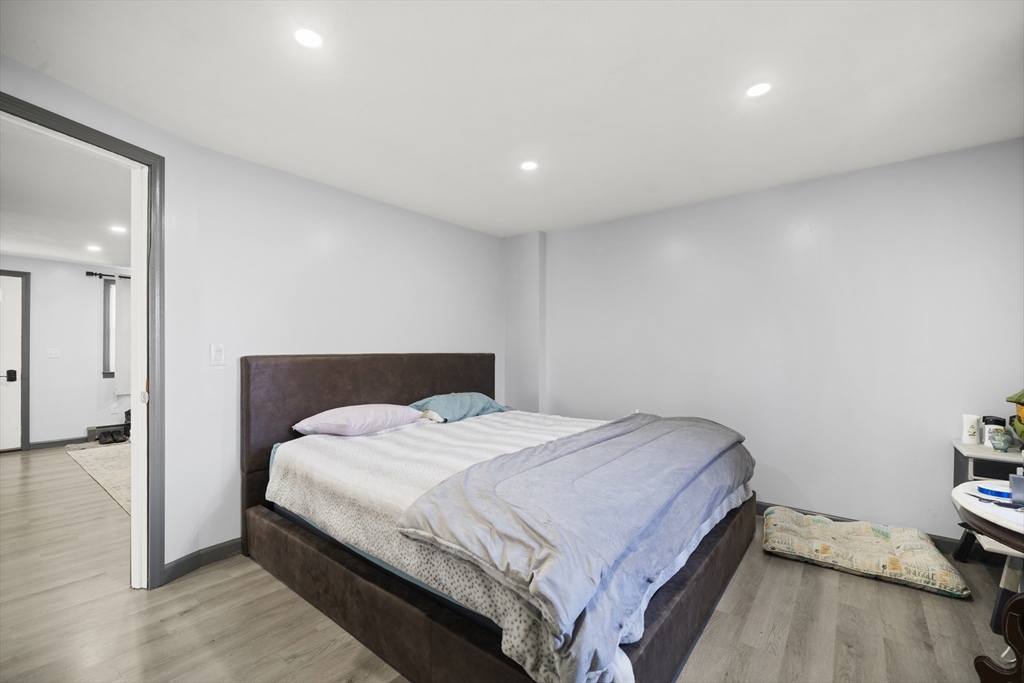 183-185 Middle Street Springfield, MA 01104 - Photo 10 of 27 a bedroom with a bed and a wooden floor