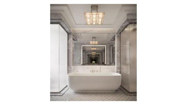 a bathroom with a bathtub a mirror and a bathtub