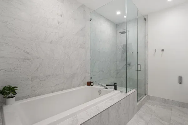 a bathroom with a bathtub and a shower