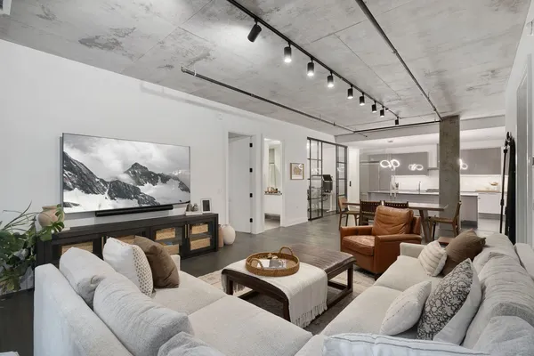 a living room with furniture and wooden floor