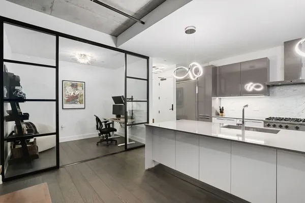 a large white kitchen with a large window