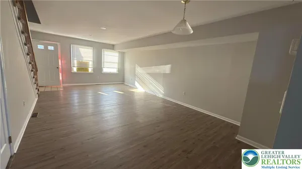 a kitchen with a sink and wooden floor