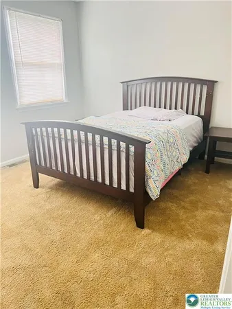 a bedroom with a bed and lamp