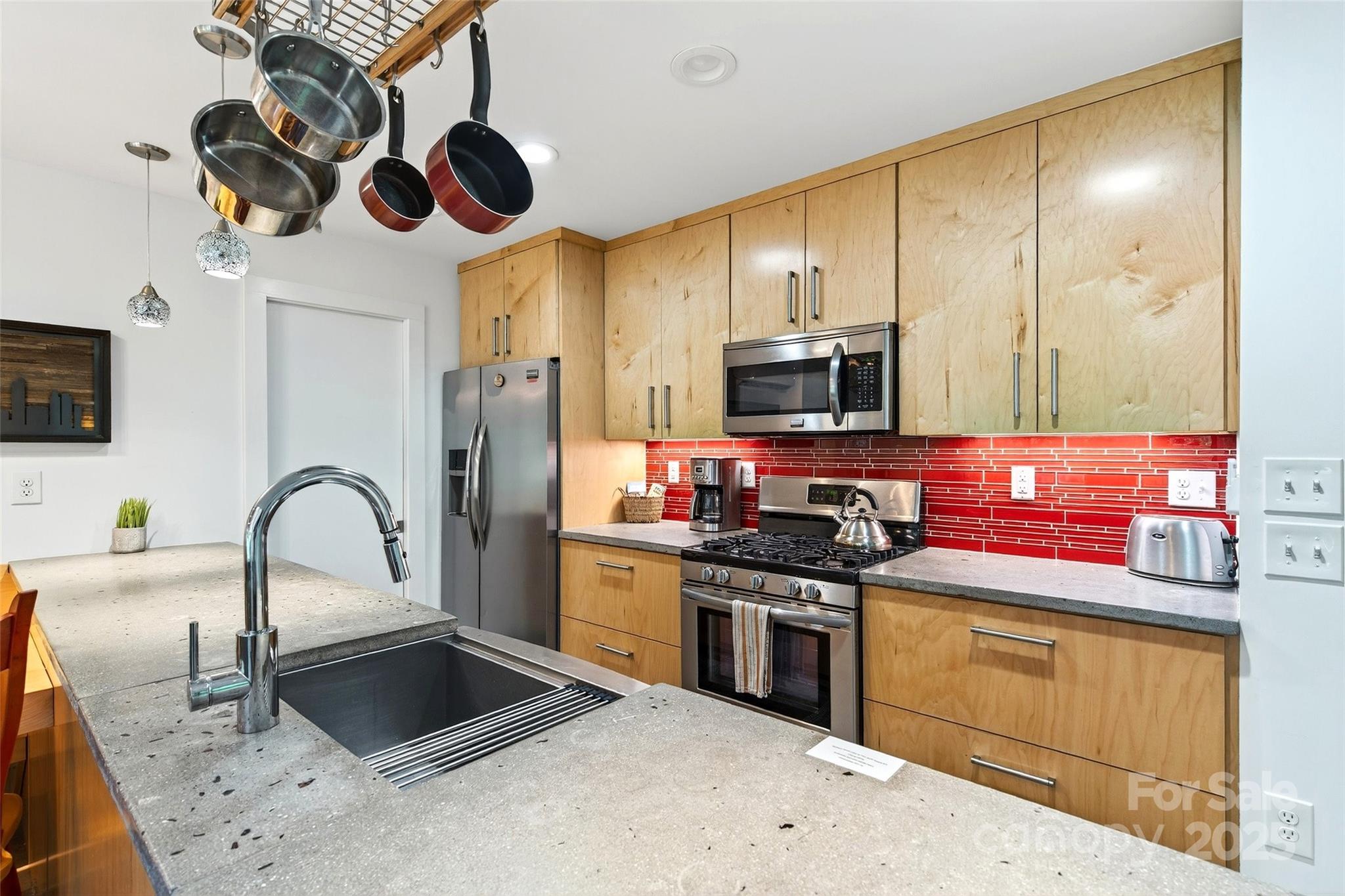 450 Lakey Gap Road Black Mountain, NC 28711 - Photo 15 of 48 a kitchen with stainless steel appliances granite countertop a stove a sink and a microwave