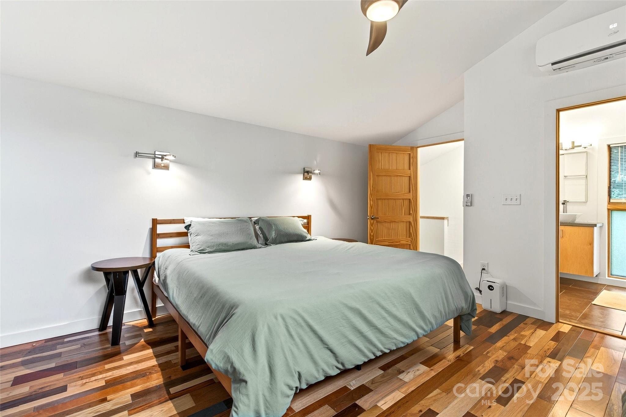 450 Lakey Gap Road Black Mountain, NC 28711 - Photo 22 of 48 a bedroom with a bed and a chandelier