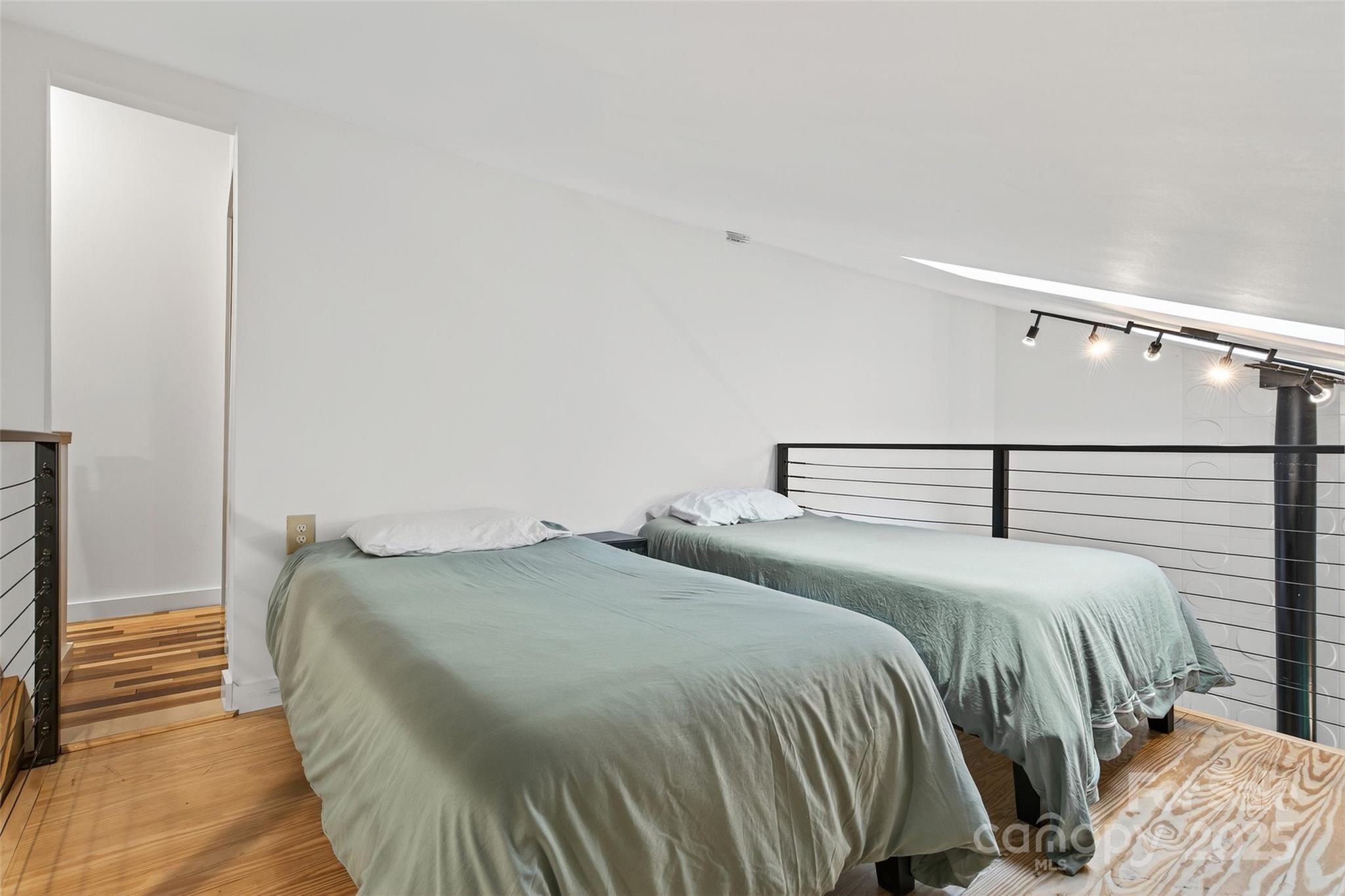 450 Lakey Gap Road Black Mountain, NC 28711 - Photo 27 of 48 a bedroom with a bed and wooden floor
