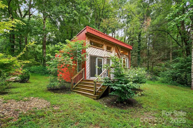 a backyard of a house with table and chairs