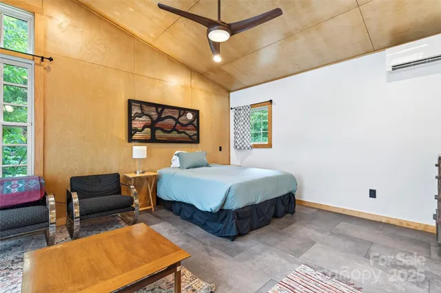 a bedroom with a bed closet and a large window