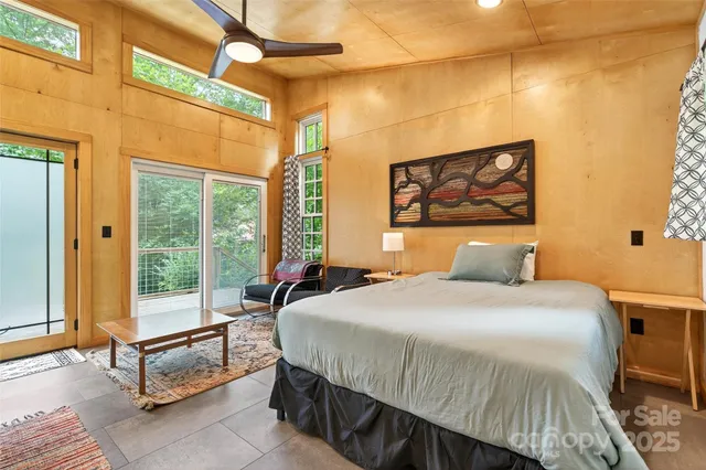 a bedroom with a bed dresser and a window