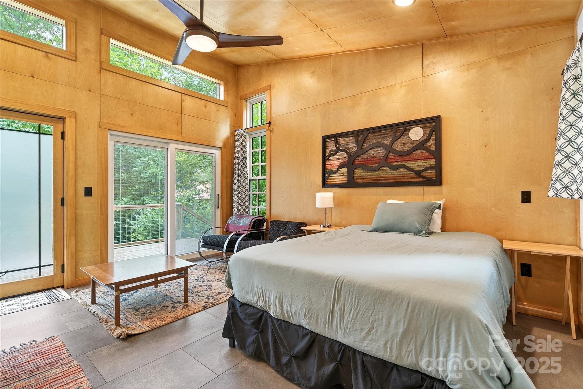 450 Lakey Gap Road Black Mountain, NC 28711 - Photo 45 of 48 a bedroom with a bed and a painting on the wall