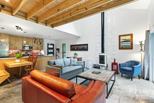 a living room with furniture and a floor to ceiling window