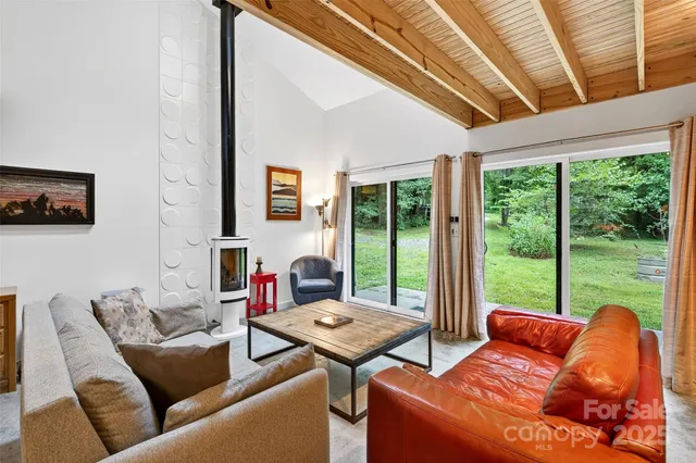 a living room with furniture and a floor to ceiling window
