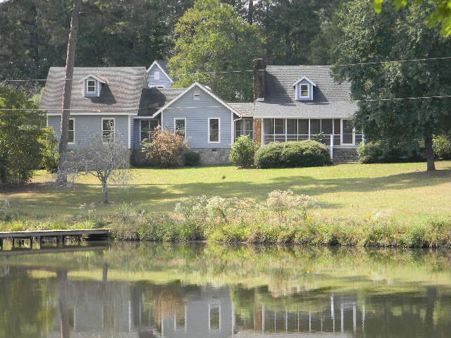 379 Howard Roberts Road Gray, GA 31032 - Photo 1 of 1 a front view of a house with a yard and potted plants