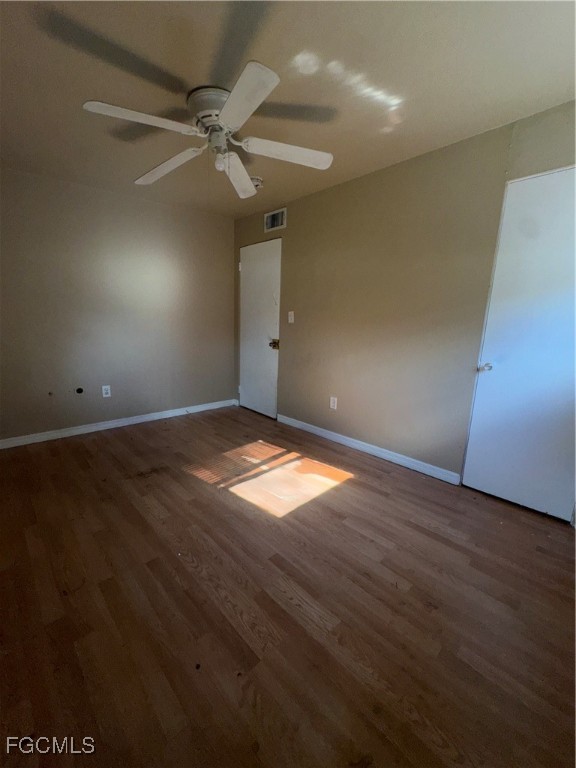 3724 Richard Road North Fort Myers, FL 33903 - Photo 12 of 17 an empty room with wooden floor and fan