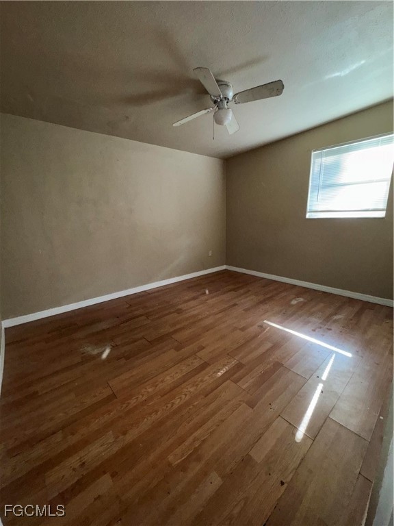 3724 Richard Road North Fort Myers, FL 33903 - Photo 15 of 17 an empty room with wooden floor fan and windows