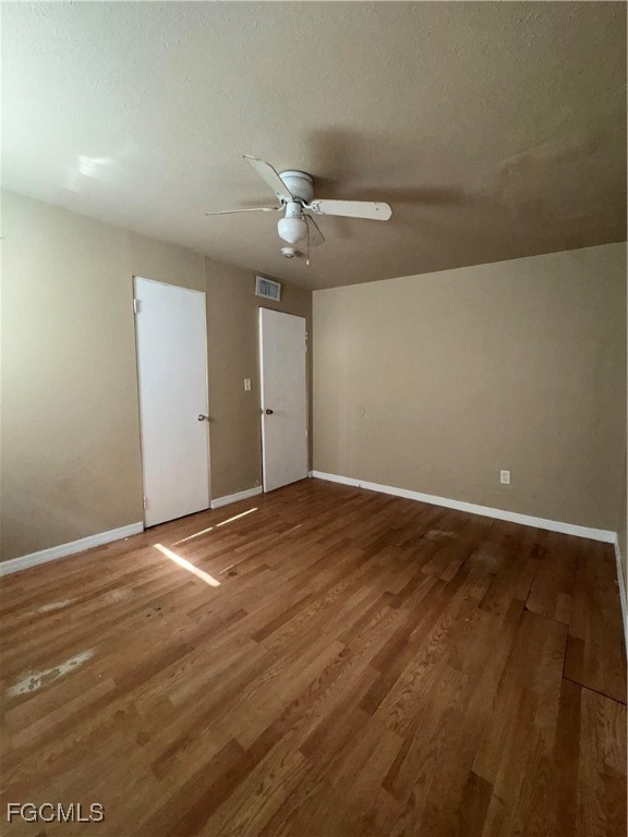 3724 Richard Road North Fort Myers, FL 33903 - Photo 16 of 17 an empty room with wooden floor and fan