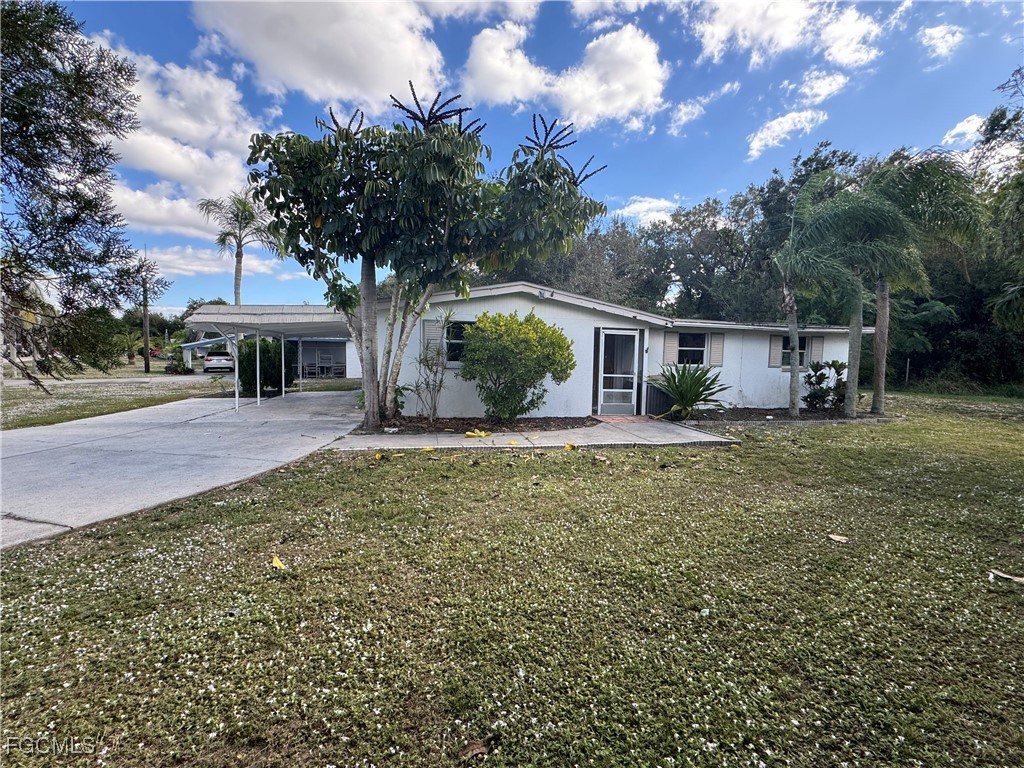 3724 Richard Road North Fort Myers, FL 33903 - Photo 2 of 17 a front view of a house with a yard