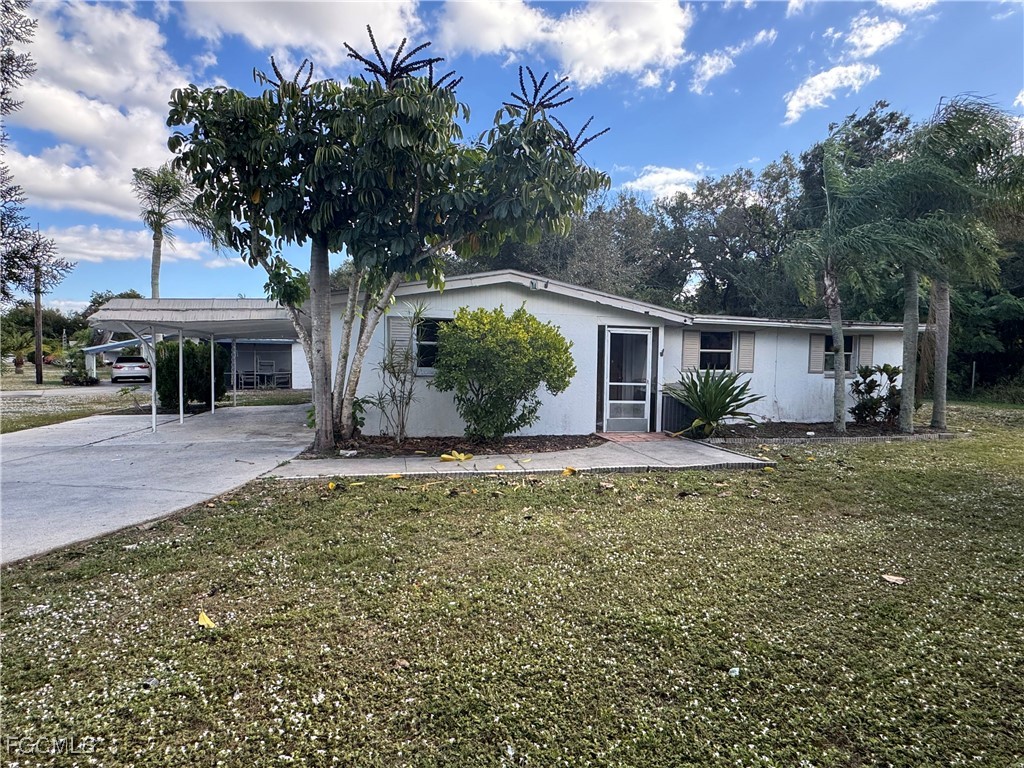 3724 Richard Road North Fort Myers, FL 33903 - Photo 3 of 17 a front view of a house with garden