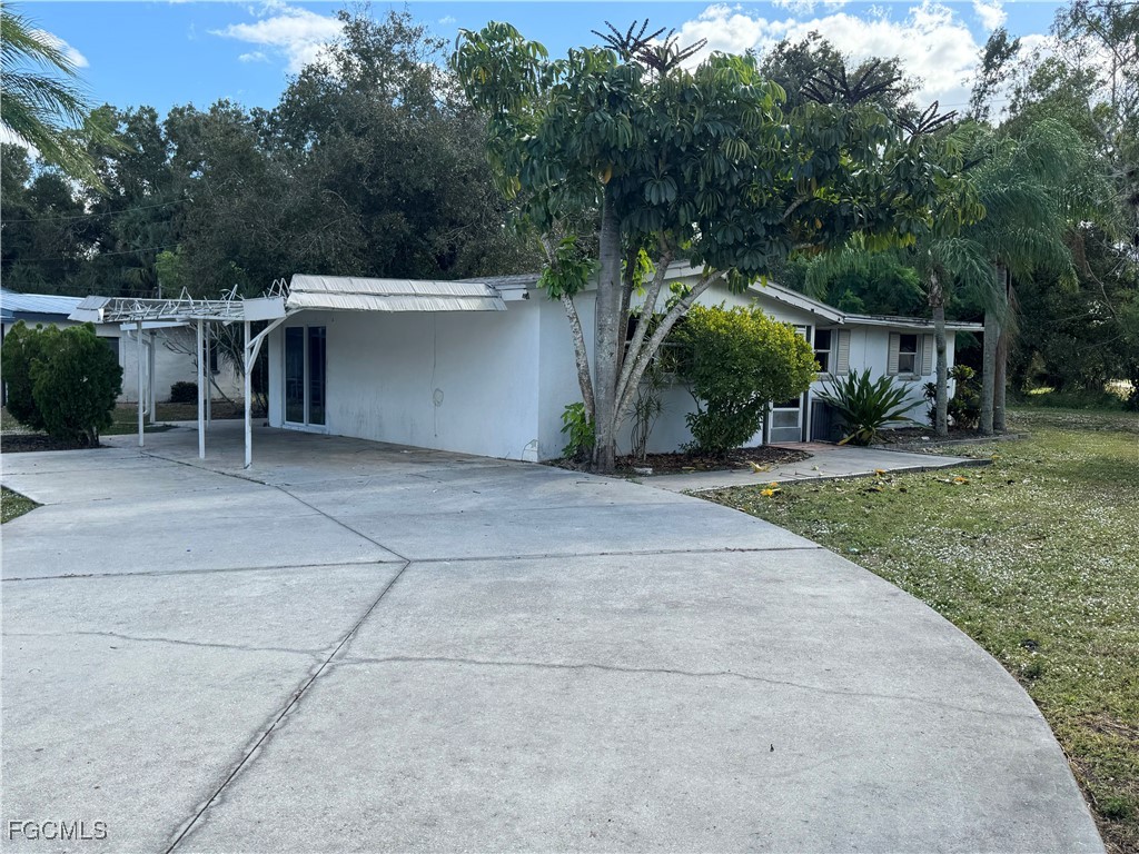 3724 Richard Road North Fort Myers, FL 33903 - Photo 4 of 17 front view of house with a yard and trees