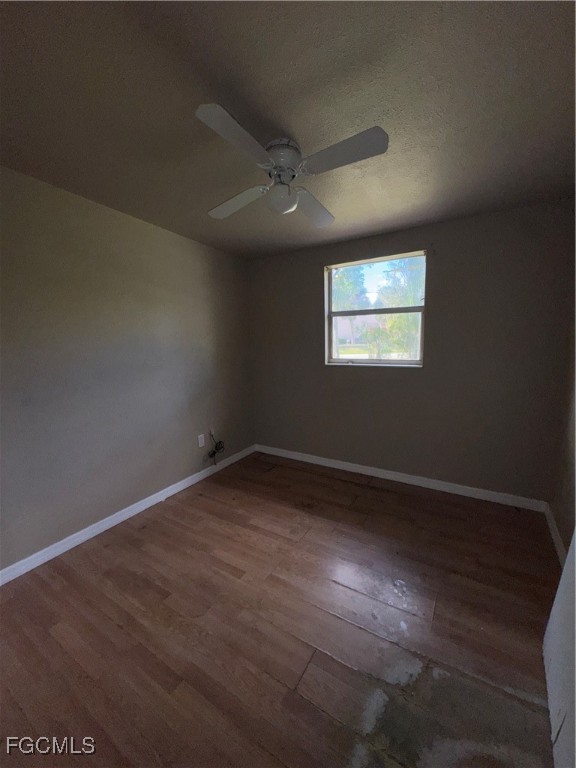 3724 Richard Road North Fort Myers, FL 33903 - Photo 9 of 17 an empty room with wooden floor and windows