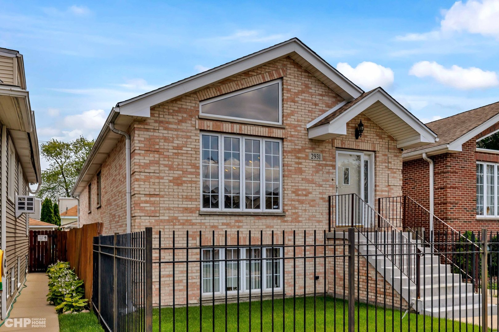 a front view of a house with a garden