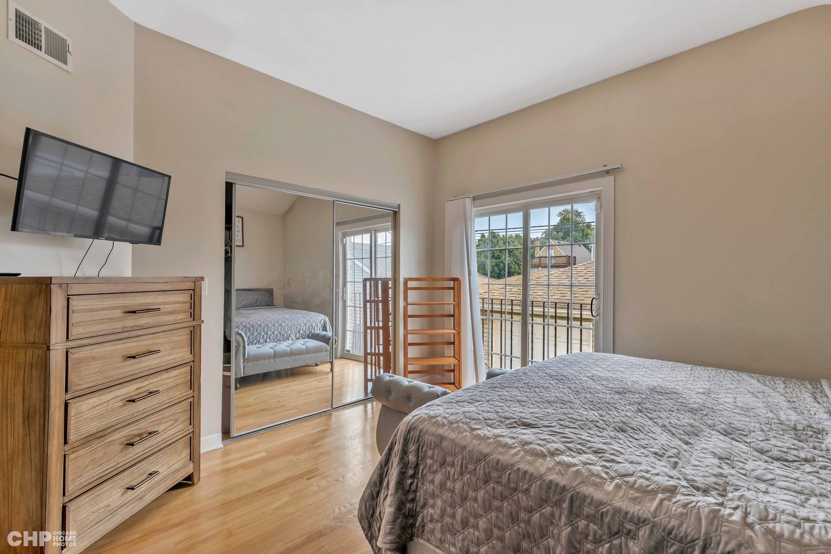 2931 North Rutherford Avenue Chicago, IL 60634 - Photo 12 of 37 a bedroom with a large bed and walk in closet