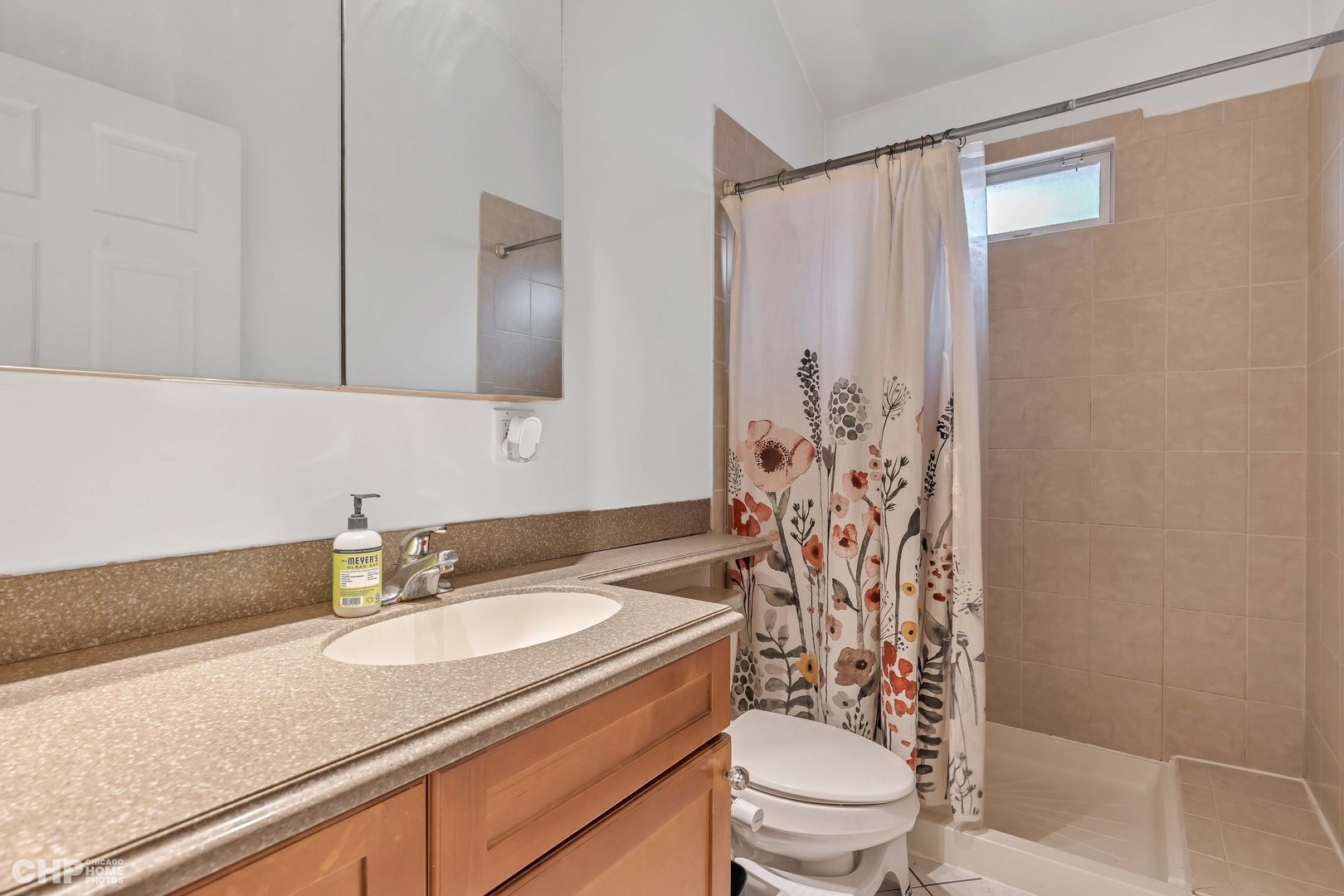 2931 North Rutherford Avenue Chicago, IL 60634 - Photo 14 of 37 a bathroom with a granite countertop sink a toilet and shower curtain