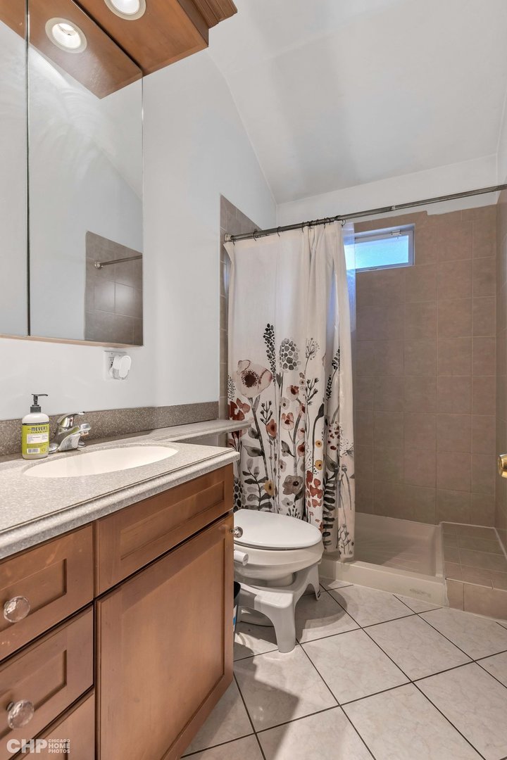2931 North Rutherford Avenue Chicago, IL 60634 - Photo 16 of 37 a bathroom with a sink a toilet and shower