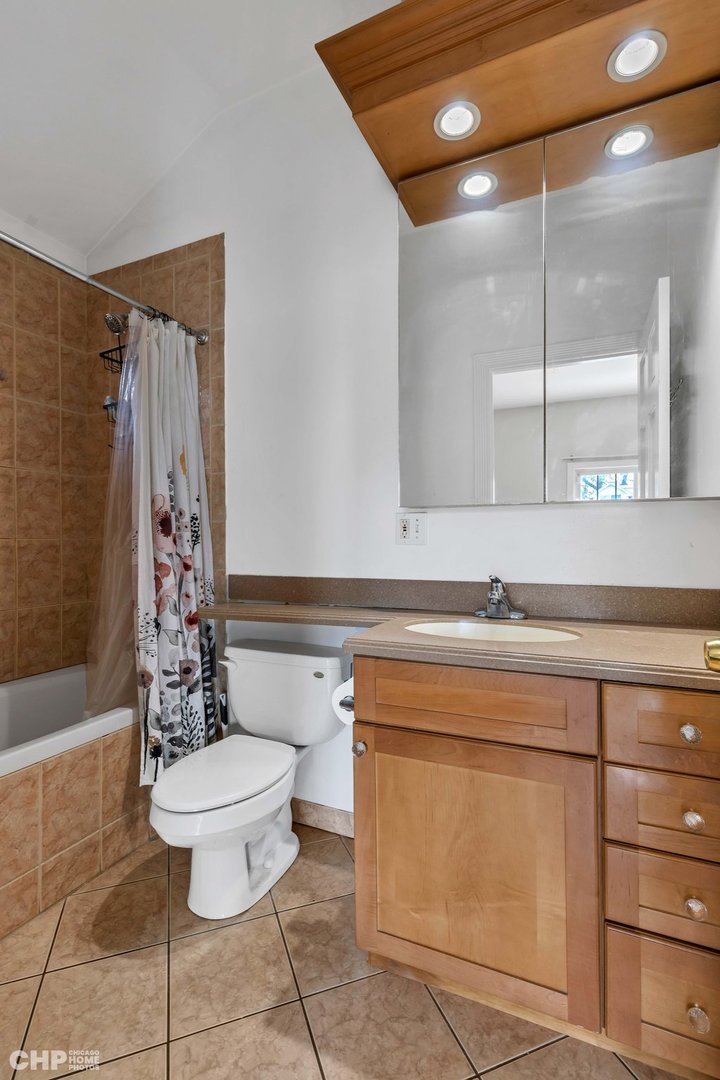 2931 North Rutherford Avenue Chicago, IL 60634 - Photo 18 of 37 a bathroom with a sink a toilet and shower