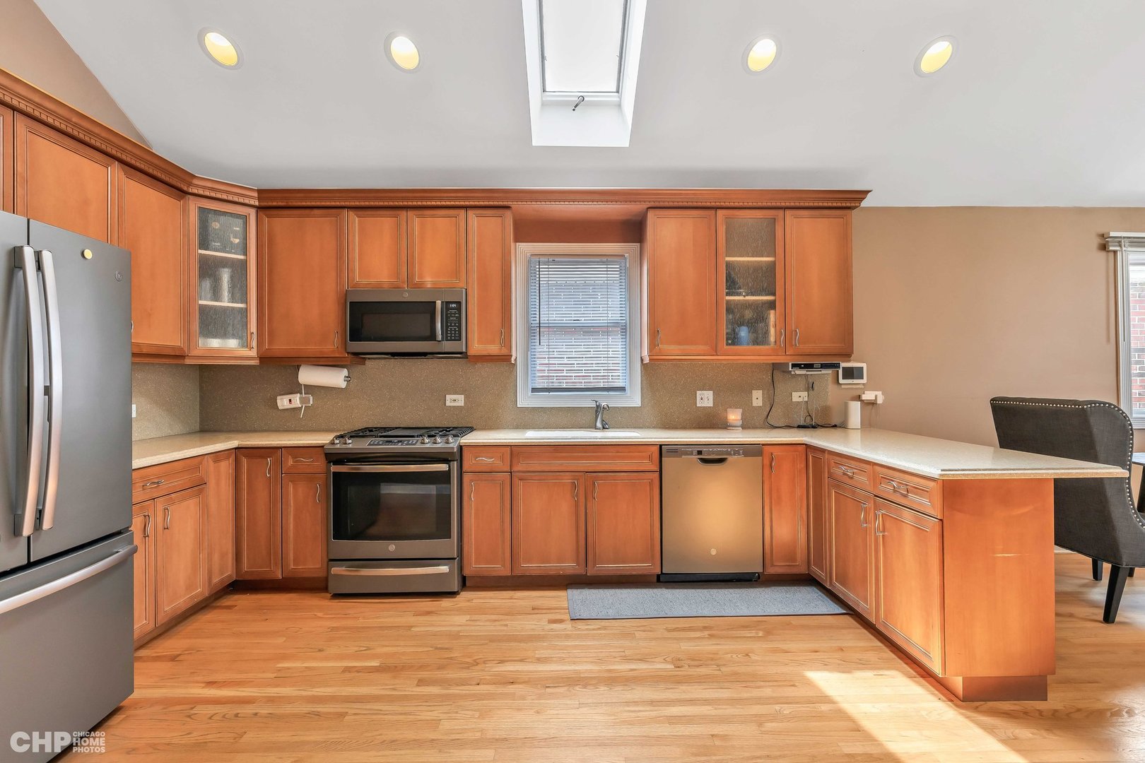 2931 North Rutherford Avenue Chicago, IL 60634 - Photo 7 of 37 a large kitchen with stainless steel appliances granite countertop a stove top oven a sink dishwasher and a refrigerator