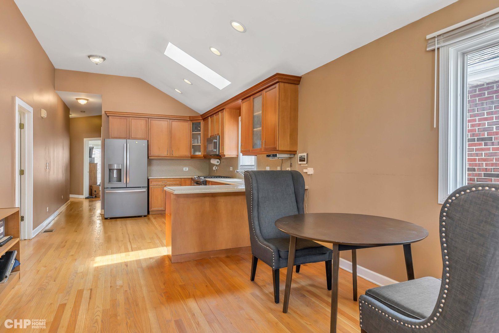 2931 North Rutherford Avenue Chicago, IL 60634 - Photo 10 of 37 a kitchen with a table chairs refrigerator and cabinets