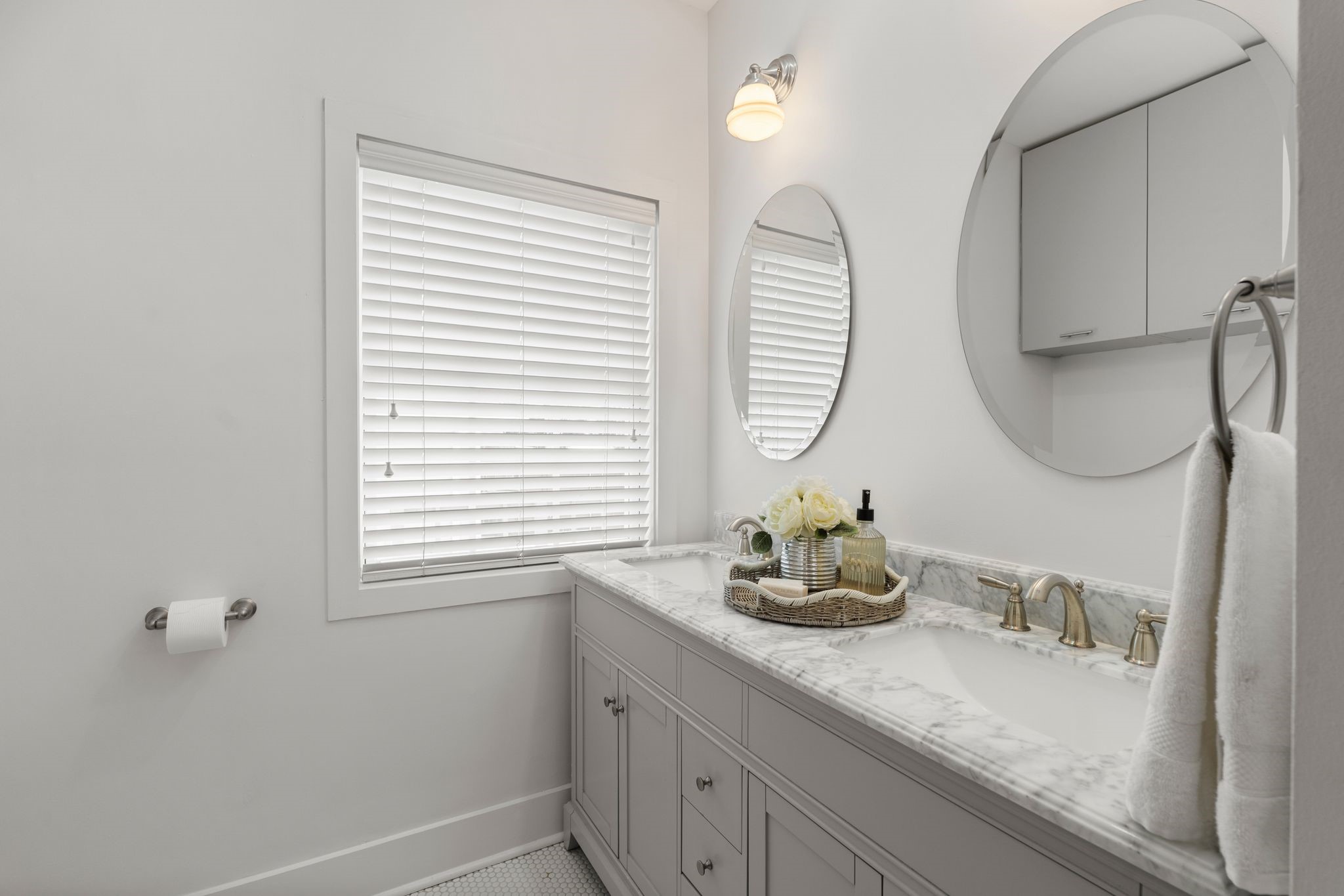 714 Ridge Street Houston, TX 77009 - Photo 18 of 36 A quartz countertop, round mirrors and sconce lighting top the wide custom double vanity.